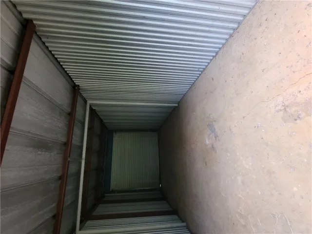 This structure features durable construction with corrugated metal siding and a concrete floor.