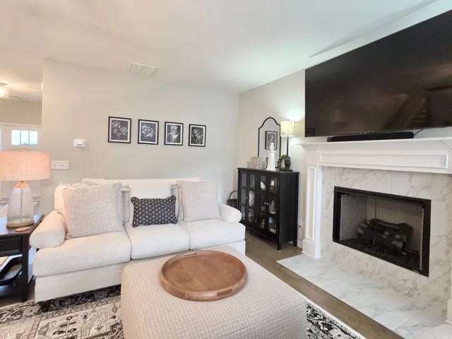 This inviting living space features a cozy fireplace, perfect for relaxation and gatherings.