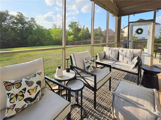 Enjoy tranquil outdoor living on this screened porch, offering serene views of the privacy fenced yard w/greenspace beyond!