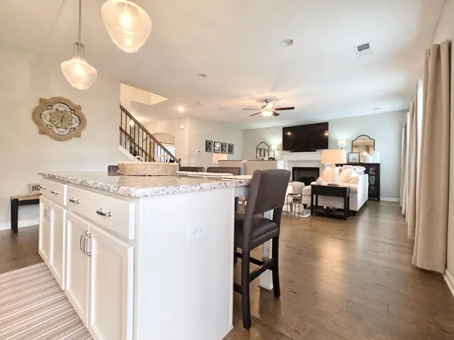 This inviting space combines a functional kitchen island with seamless access to the living area.