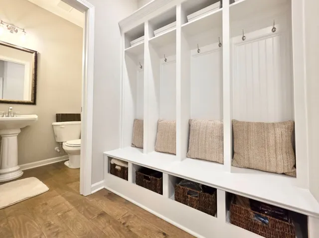 This versatile mudroom offers practical storage solutions with its built-in cubbies and hardwood flooring.