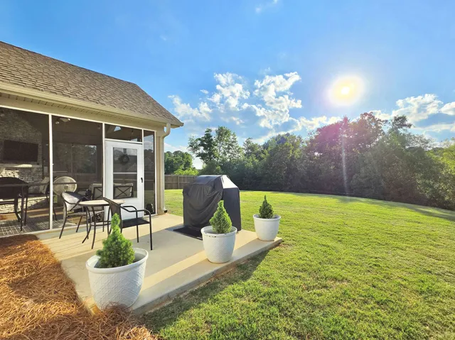 Grilling Patio off the screened porch overlooks the sprawling backyard.