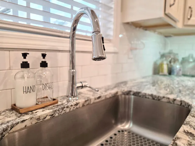 This modern kitchen features elegant countertops and a sleek sink.