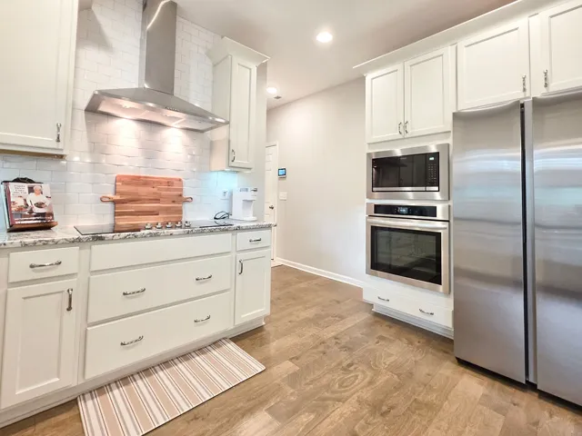 This kitchen features sleek countertops, pristine cabinetry, and a full suite of stainless steel appliances.