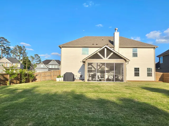 This residence boasts a spacious backyard perfect for outdoor gatherings and serene enjoyment.