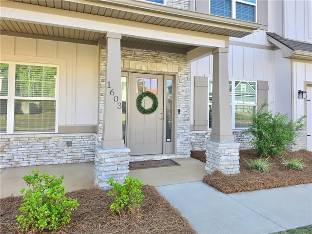 Welcoming Craftsman style front porch says come on in!