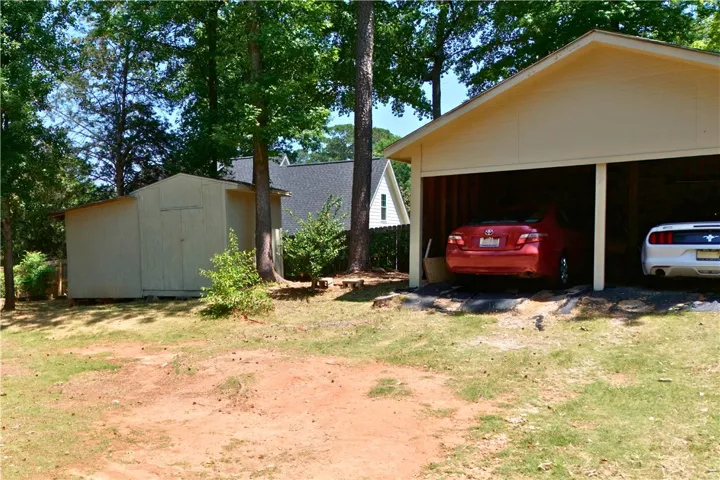 This property features ample outdoor storage and a convenient two-car open garage.