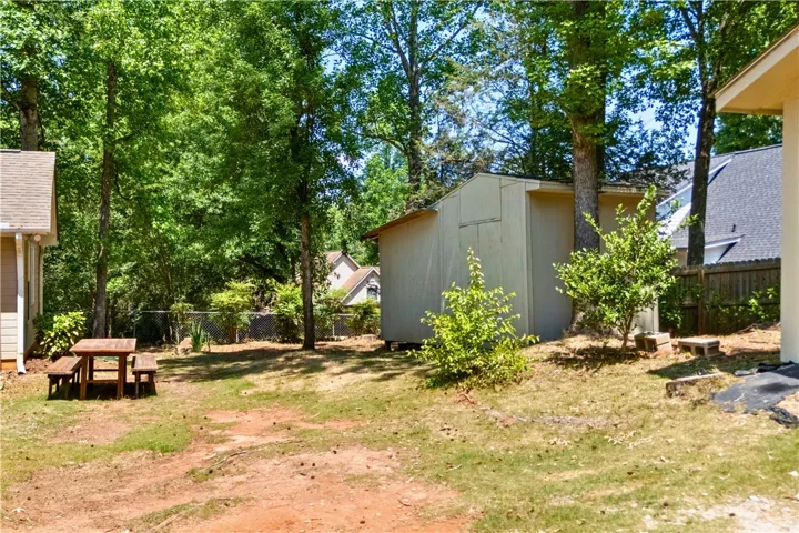 This spacious backyard provides ample room for outdoor activities and relaxation.