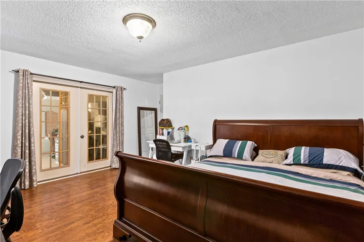 This master bedroom features elegant French doors that open to the enclosed porch.