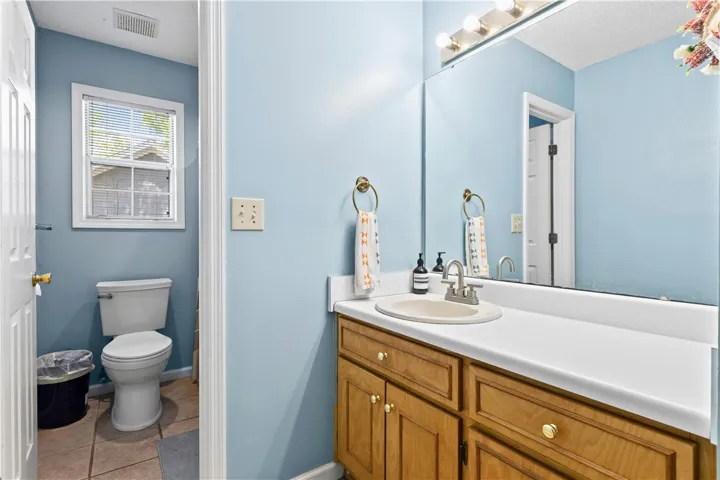 This clean bathroom features a functional vanity and bright lighting, perfect for daily routines.