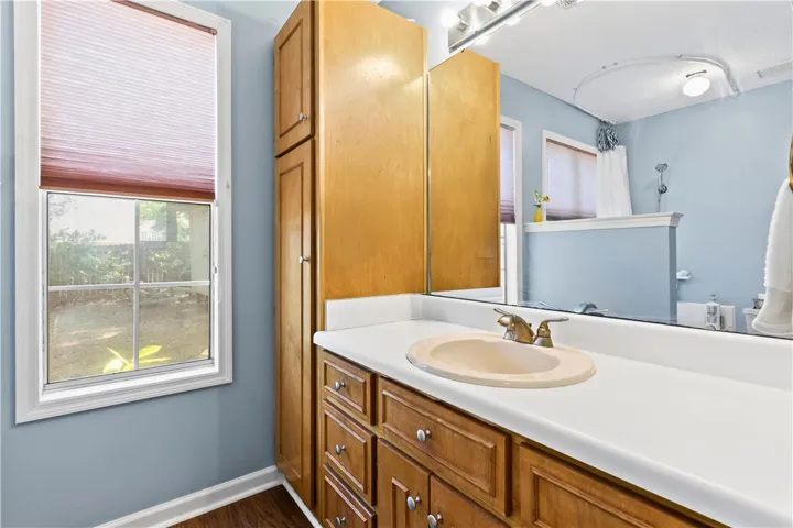 This master bathroom features a sleek vanity with ample storage and windows offering natural light.