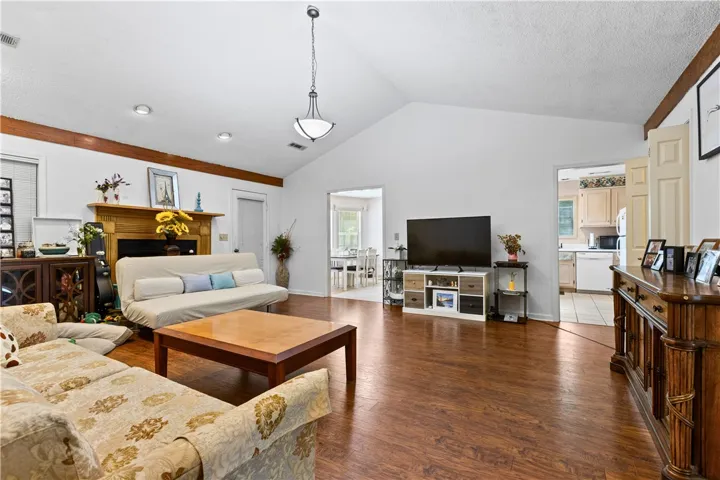This living area features a warm fireplace and flows into a bright dining space.