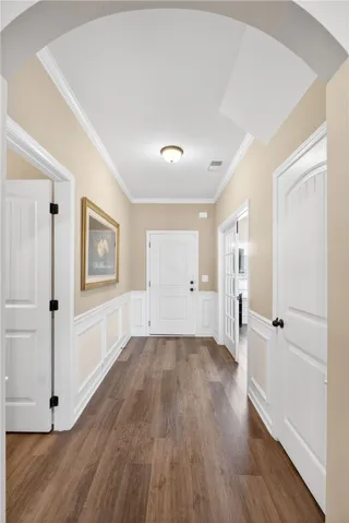 A welcoming entryway features classic wainscoting, creating an inviting first impression.