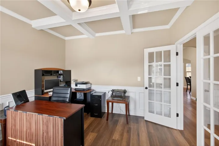 An inviting office with elegant coffered ceilings provides a perfect work-from-home setting.