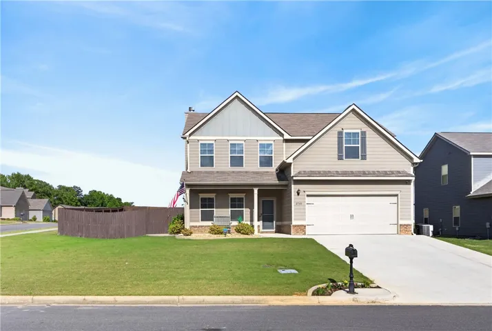 This inviting residence features a well-maintained lawn and a welcoming facade.