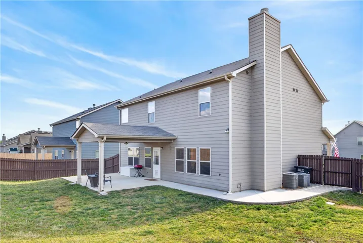 This residence offers a private yard with a covered patio perfect for outdoor living.