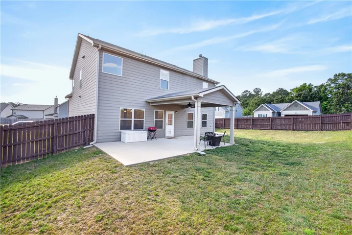 This spacious backyard offers a private oasis for outdoor living and entertaining.