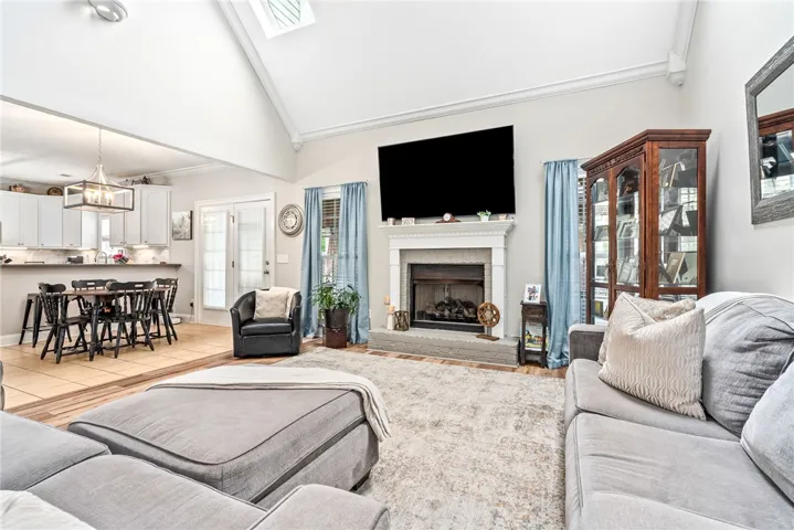 This bright living area features a fireplace and offers a spacious open-concept layout.