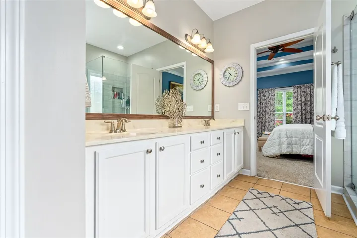 The primary bathroom features a dual vanity