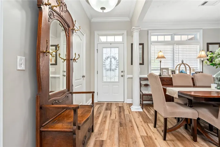 This inviting entryway showcases durable flooring and abundant natural light, perfect for welcoming guests.