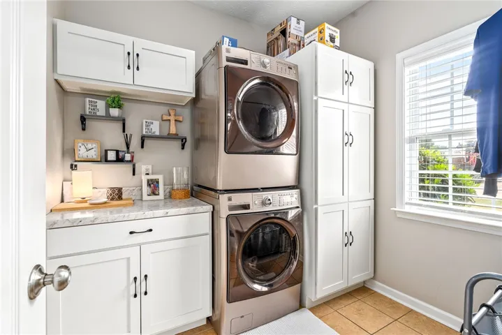 This organized laundry area features ample storage for everyday convenience.