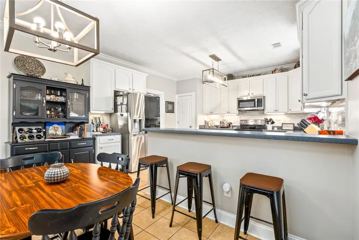 This bright kitchen offers a practical layout with bar seating and ample cabinetry.