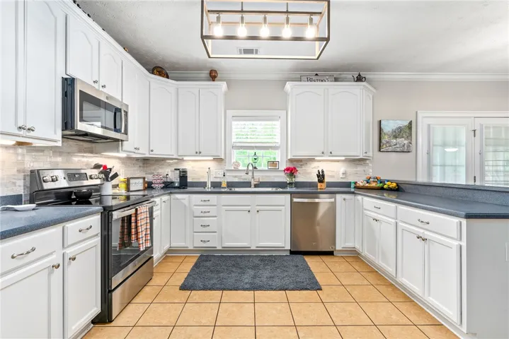 This spacious kitchen offers ample storage and modern appliances for culinary pursuits.