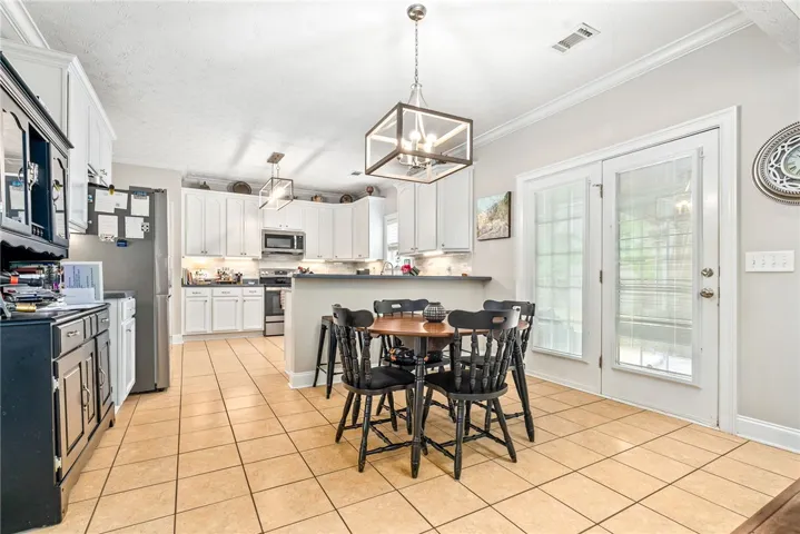 The spacious kitchen offers casual dining and outdoor access.