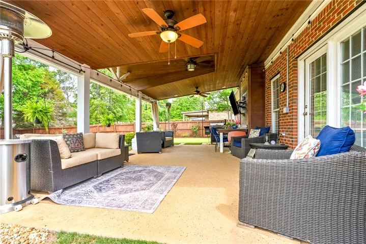 This inviting patio with a wood ceiling offers an ideal outdoor living space for relaxation and entertainment.