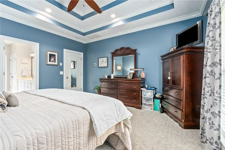 The primary bedroom features an elegant tray ceiling, perfect for peaceful rest.