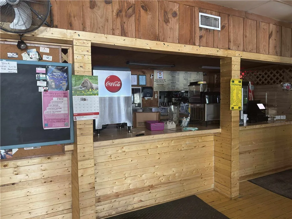 This commercial space features natural wood paneling, offering a rustic yet inviting atmosphere for business.