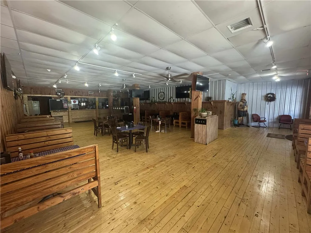 This spacious commercial interior features warm wood paneling and bright lighting, creating an inviting atmosphere.