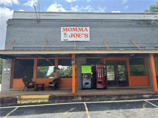 This commercial building features a brick exterior and a welcoming covered porch area.