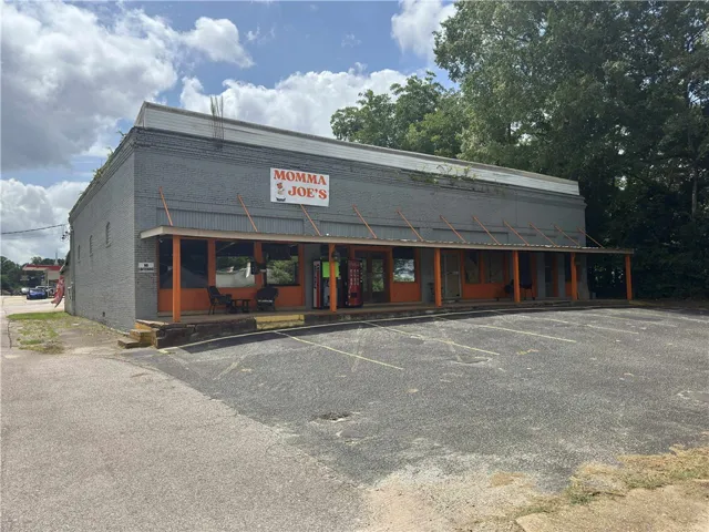 This commercial building offers a spacious storefront and ample parking for customers.