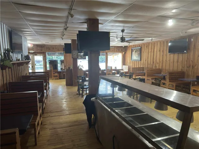 This spacious interior offers an inviting atmosphere with natural wood accents and abundant seating.