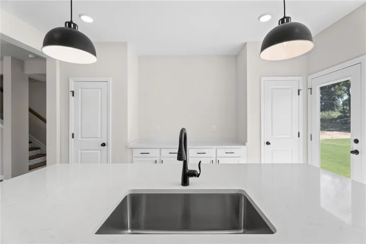 A well-appointed kitchen island with sleek counters and a modern sink.