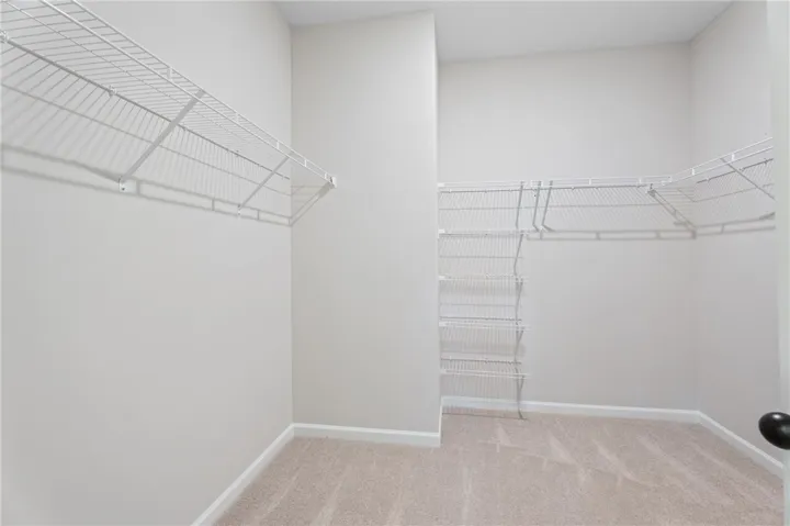 Organized living made effortless with built-in wire shelving within a roomy closet.