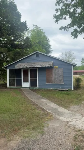 This cozy home offers a charming facade with a welcoming front porch, perfect for enjoying peaceful moments.