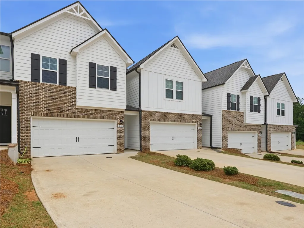 These modern townhomes feature inviting exteriors with durable materials and convenient attached garages.