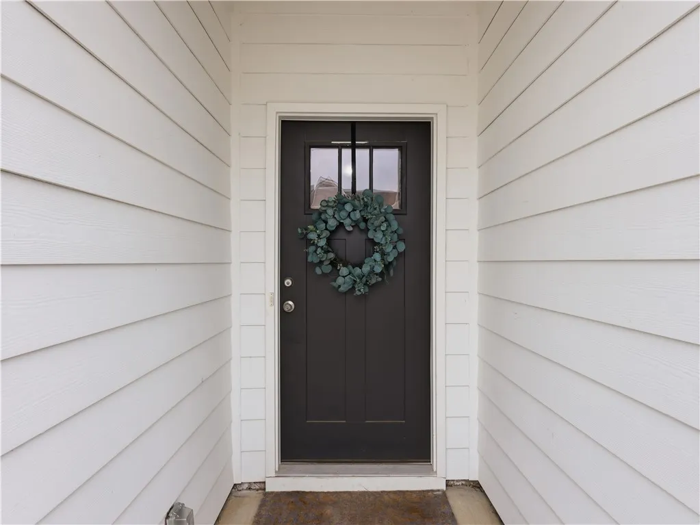 Welcome guests through a classic front door, framed by clean, inviting siding.