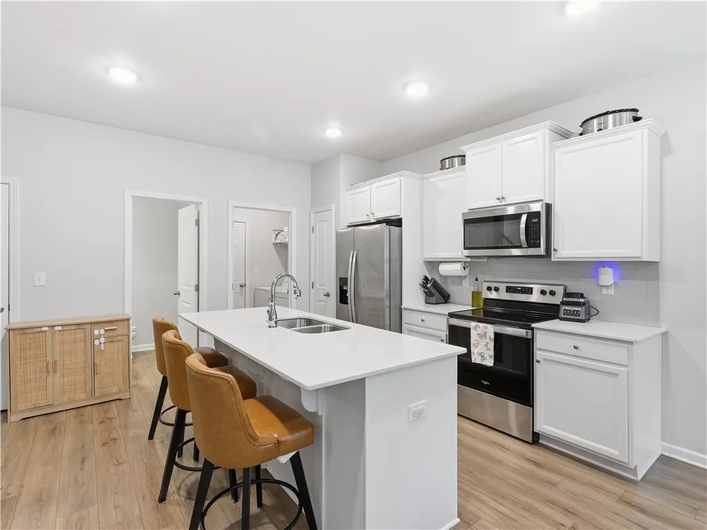 This spacious kitchen offers a bright and inviting atmosphere with modern finishes and ample counter space.
