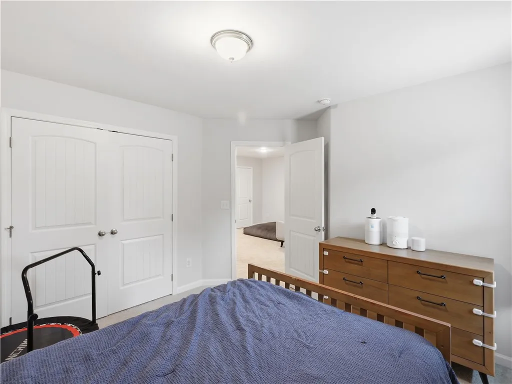 This cozy bedroom offers a tranquil retreat with soft lighting and ample closet space.