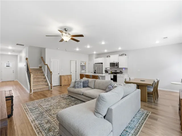 This bright and open-concept space seamlessly integrates living, dining, and kitchen areas.