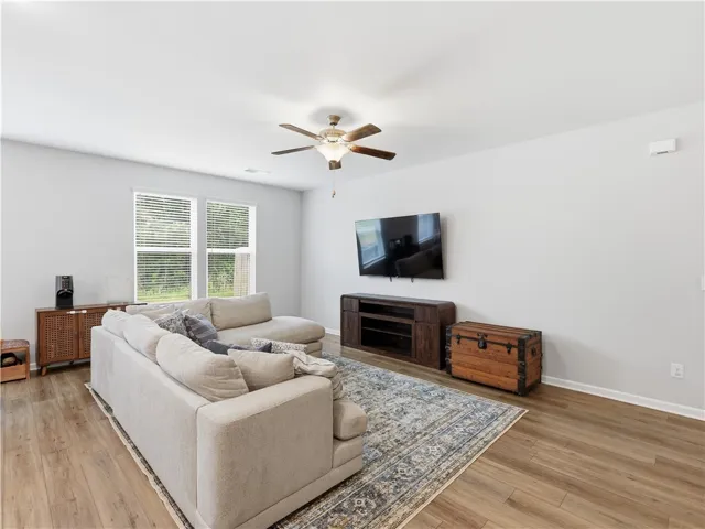 This bright living area features ample natural light and durable flooring, perfect for comfortable daily living.