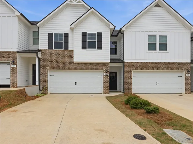 This newly constructed townhome features modern architectural details and individual garages, offering comfort and style.