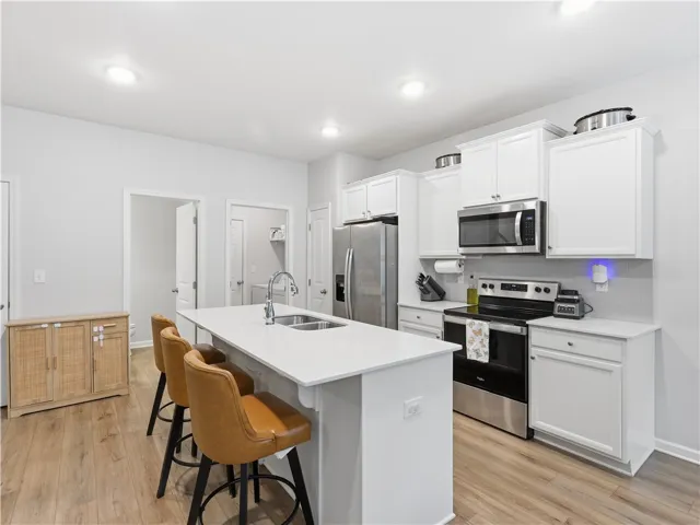 This spacious kitchen offers a bright and inviting atmosphere with modern finishes and ample counter space.