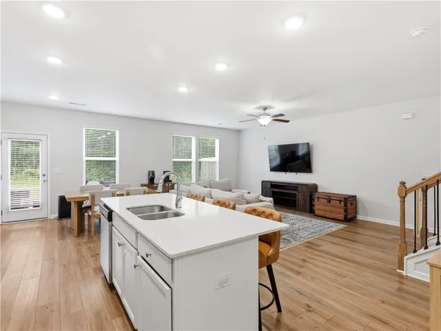 This bright and airy open-concept space features a well-appointed kitchen and inviting living area.