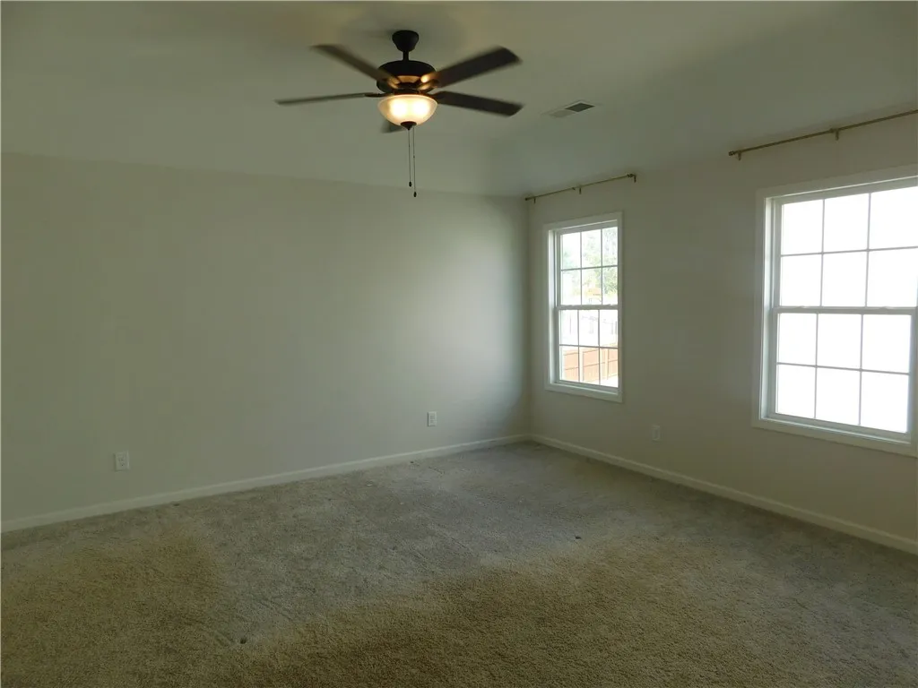 This spacious room features ample natural light and a comfortable atmosphere for rest and relaxation.