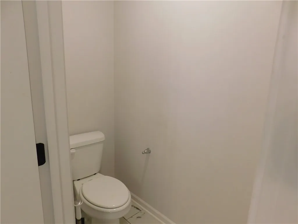 This clean and functional powder room features practical finishes for everyday convenience.