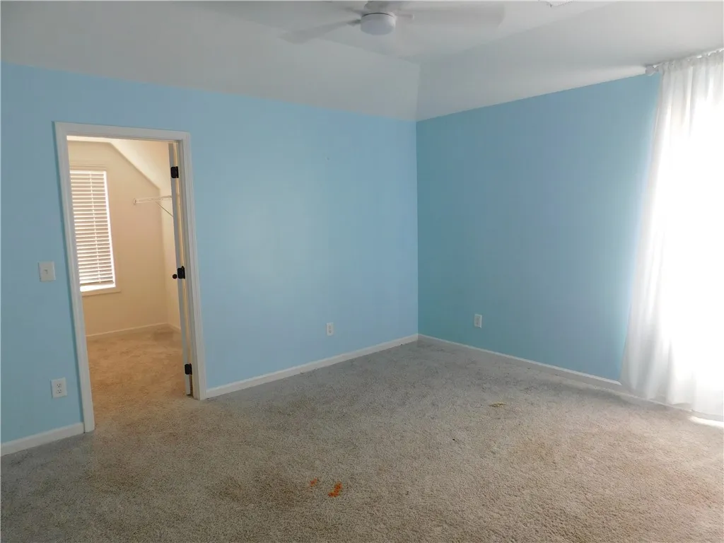 Bright and airy bedroom offering a cozy retreat with ample natural light.